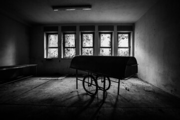 February 2022, creepy stretcher carries corpses with lid of an abandoned asylum, in Italy, urbex