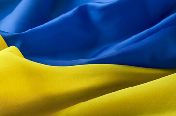 Fabric textured flag of Ukraine, UA. Blue and yellow colors. Close up shot, selective focus,...