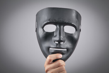 Man holding black mask. Fake, anonymous