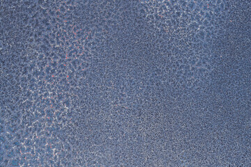 Old peeling paint on sheet metal.