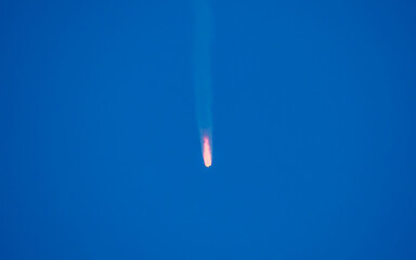 Flying comet meteorite in the blue sky. Armageddon threat