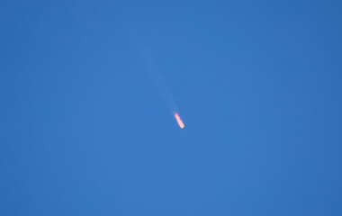 Flying comet meteorite in the blue sky. Armageddon threat