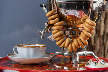 Russian pancakes blini with samovar tea cup and drying on the table. Shrovetide Maslenitsa festival concept.