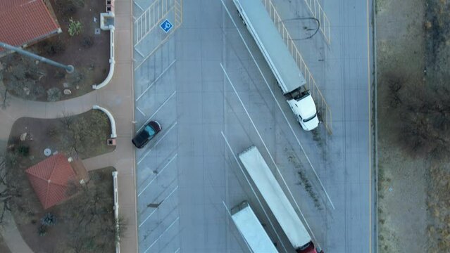 Aerial of semi trucks parked for the night at a rest area