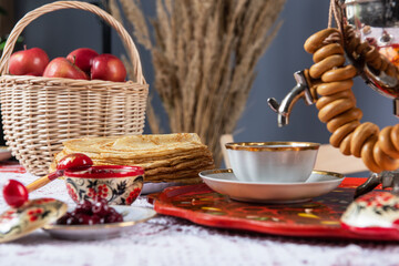 Russian pancakes blini with samovar tea cup and drying on the table. Shrovetide Maslenitsa festival...