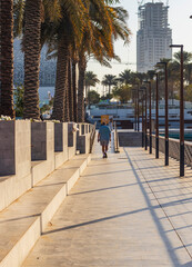 Dubai, UAE - 02.11.2022 - Senior person walking in the morning at Dubai creek harbour area. City