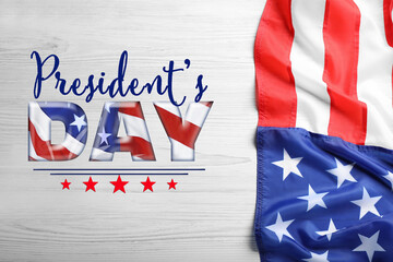 Fototapeta na wymiar Happy President's Day - federal holiday. American flag and text on white wooden background, top view