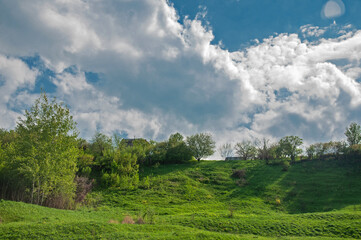 Summer rural landscape with blue cloudy sky