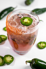 Pink cocktail with spicy jalapenos
