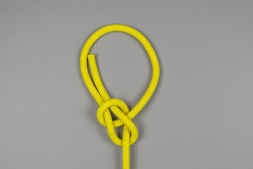 Rope knot on gray background