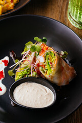 asian spring rolls with vegetables on a wooden background. resta