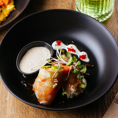 asian spring rolls with vegetables on a wooden background. resta