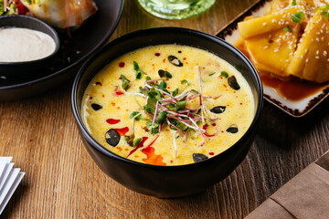 asian vegetarian corn soup on a wooden background. restaurant me