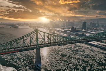 Montreal City Jacques Cartiers bridge and downtown buildings in the background with sunset sky