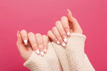  female hands with beautiful long nails with  manicure with  heart pattern in winter clothes © Maya Kruchancova