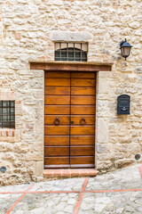 Vintage front door in the medieval city of Italy. Ancient wooden gate. Old city streets, beautiful doors and unusual door handles.