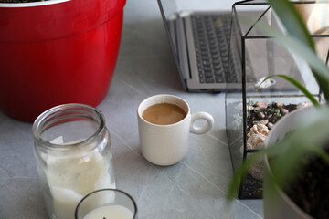 Morning coffee on the desktop near the computer