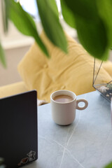 Morning coffee on the desktop near the computer