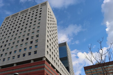 Fototapeta premium Genova, Italy - January 29, 2022: Beautiful modern high-rise buildings against the sky. 3d illustration on the theme of business success and technology. clouds reflection on the mirror.