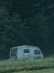 A caravan in a dense forest in the morning