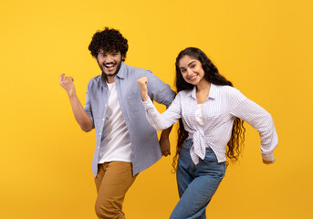 Having fun. Portarit of overjoyed indian couple dancing and fooling around, enjoying favorite music together