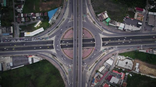 traffic at nightcar traffic transportation above circle roundabout road in Asian city. Drone aerial view fly in circle, high angle. Public transport or commuter city life concept
