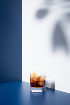 Red vermouth served in glass on blue and white background
