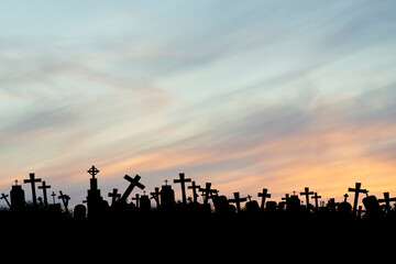 Naklejka na ściany i meble silhouettes of crowded tombs at sunset