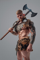 Formidable viking with strong body holding two handed axe