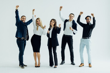 Obraz premium Happy business group. Young business team celebrating victory isolated on white background