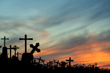 silhouettes of crowded tombs at sunset