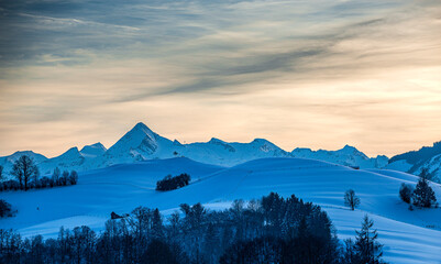 winterly landspae in region of Saalfelden in Pinzgau in Salzburger Land. Snowcovered summits of...