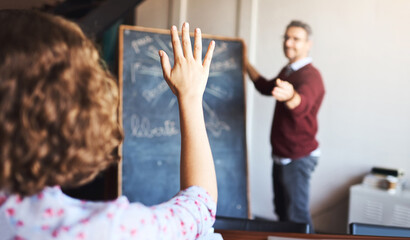 Dont be afraid to ask questions. Shot of an unrecognizable woman raising her hand to ask a question in a meeting.