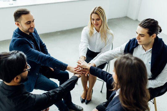 Successful diverse multiracial business team giving a high fives gesture as they celebrate in a conference room in an office