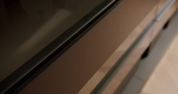 Close up wood furniture object. Closeup of beautiful chest of drawers in cozy modern room with the push system. Storage Room