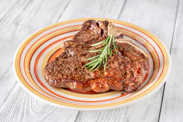 Pan-fried T-bone steak with fresh rosemary