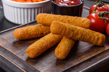 Breaded mozzarella cheese sticks served with tomato sauce