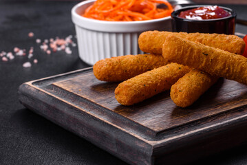 Breaded mozzarella cheese sticks served with tomato sauce