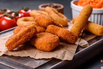 Chicken breast nuggets with two popular sauce on wooden background