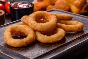 Homemade crunchy fried onion rings with tomato sauce