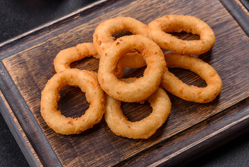 Homemade crunchy fried onion rings with tomato sauce