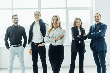 Portrait of successful creative business team looking at camera and smiling. Diverse business people standing together at start up.