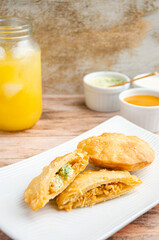 Traditional Venezuelan food with guasacas and orange juice. Rustic and wooden background