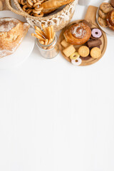 banner top view pastries, buns, grissini, bread, cookies on a white background, home bakery, delicious muffin - obrazy, fototapety, plakaty