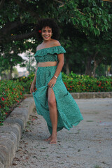 Young beautiful African woman with perfect smooth skin in tropical leaves. Concept of natural...