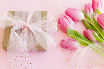 Happy Mothers day. Pink tulips bouquet and gift box on pink background. Happy womens day. 8 march. Greeting card. Gentle image