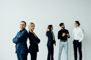 Obraz premium Businesswoman and businessman on the foreground of his collegues