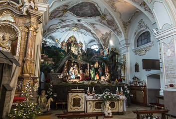 Fototapeta na wymiar St. Anna, Poland, January 22, 2022: Fragment of the interior of the Basilica of St. Anna in the international shrine of St. Anna . Additional figures and decorations related to the Christmas period.