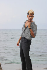 Portrait of cool young african man dancing at the beach on summer day