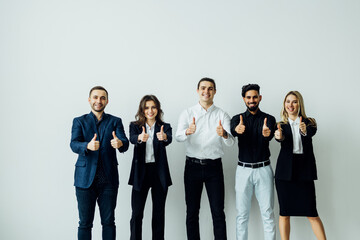 Obraz premium Sign of quality. Group of six diverse multiethnic young people clients customers standing in line looking at camera demonstrating thumbs up